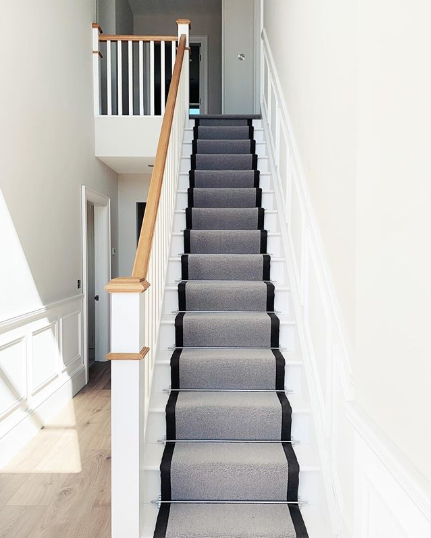 grey stair runner with black binding on white stairs